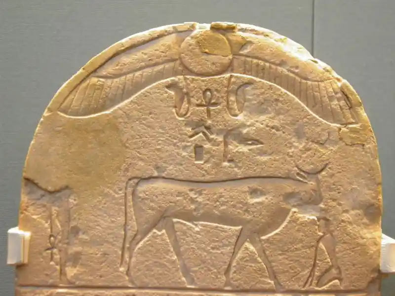 Stone stela with winged solar disc, uraeus, and buchis bull